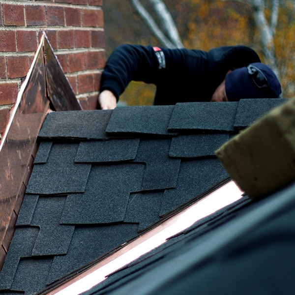 BCM Roofer repairs flashing on a roof in White Lake Township Michigan