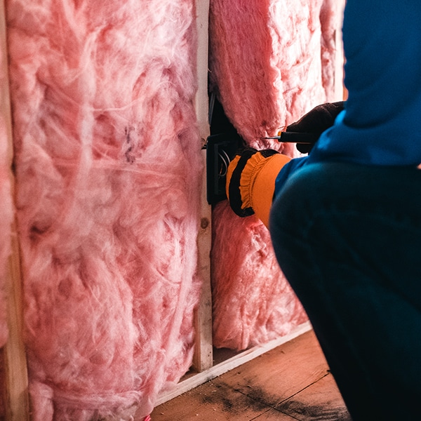 BCM Roofing installing attic insulation.