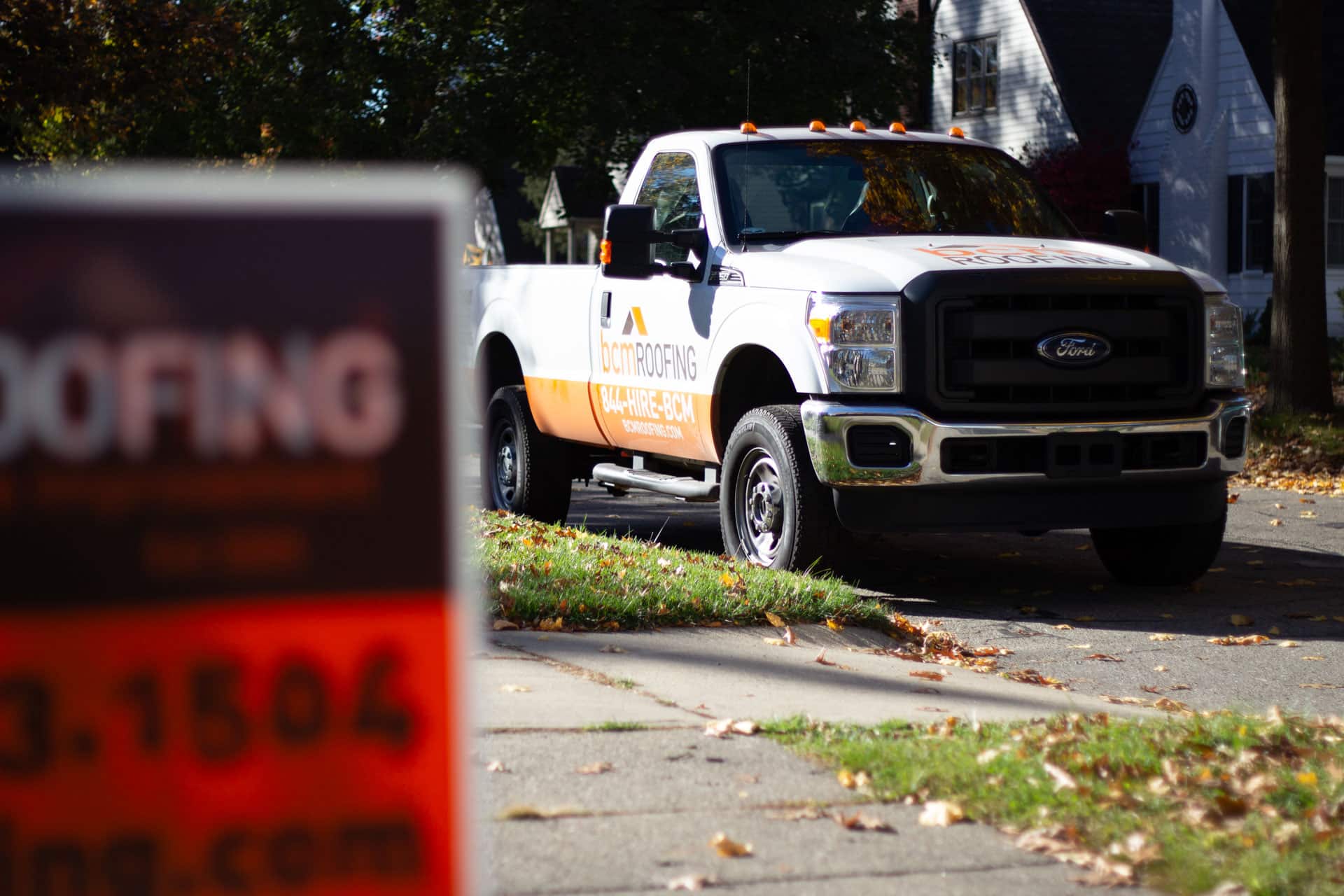 BCM Roofing work truck in a neighborhood in Rochester Hills Michigan