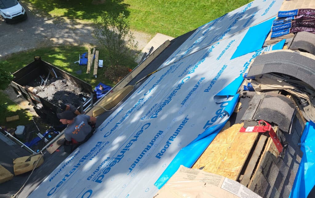 BCM Roofing removing old roof shingles