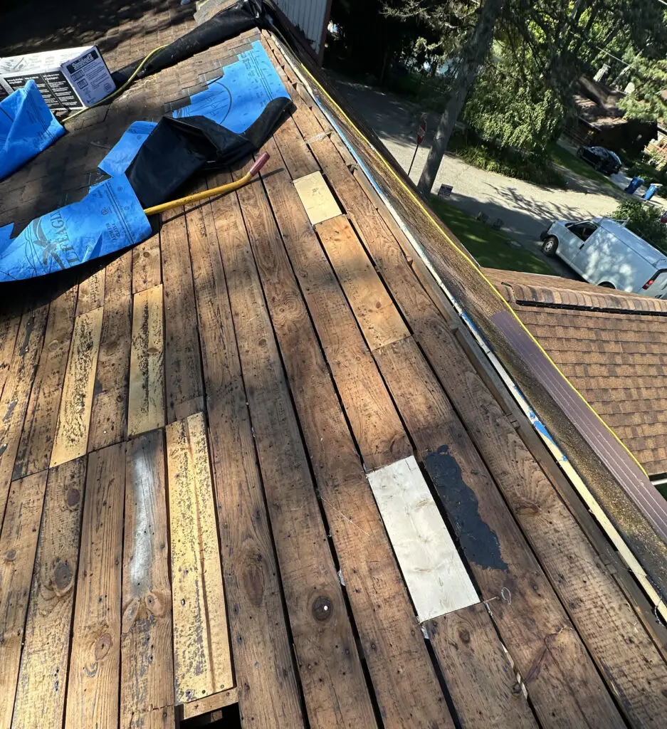 Roof Repair & Installation in Waterford Township with new Skylight 26 exposed roof decking with visible repair patches during roof replacement in waterford township mi