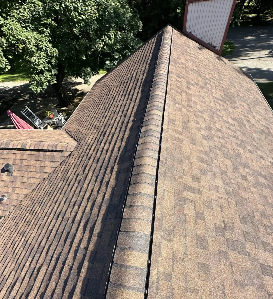 Roof Repair & Installation in Waterford Township with new Skylight 42 new ridge vent running along the peak of a residential shingle roof in waterford township mi