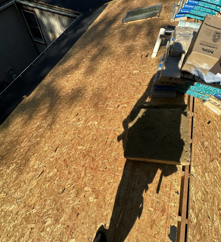 Roof Repair & Installation in Waterford Township with new Skylight 28 roof stripped to wood decking during residential roof replacement in waterford township mi