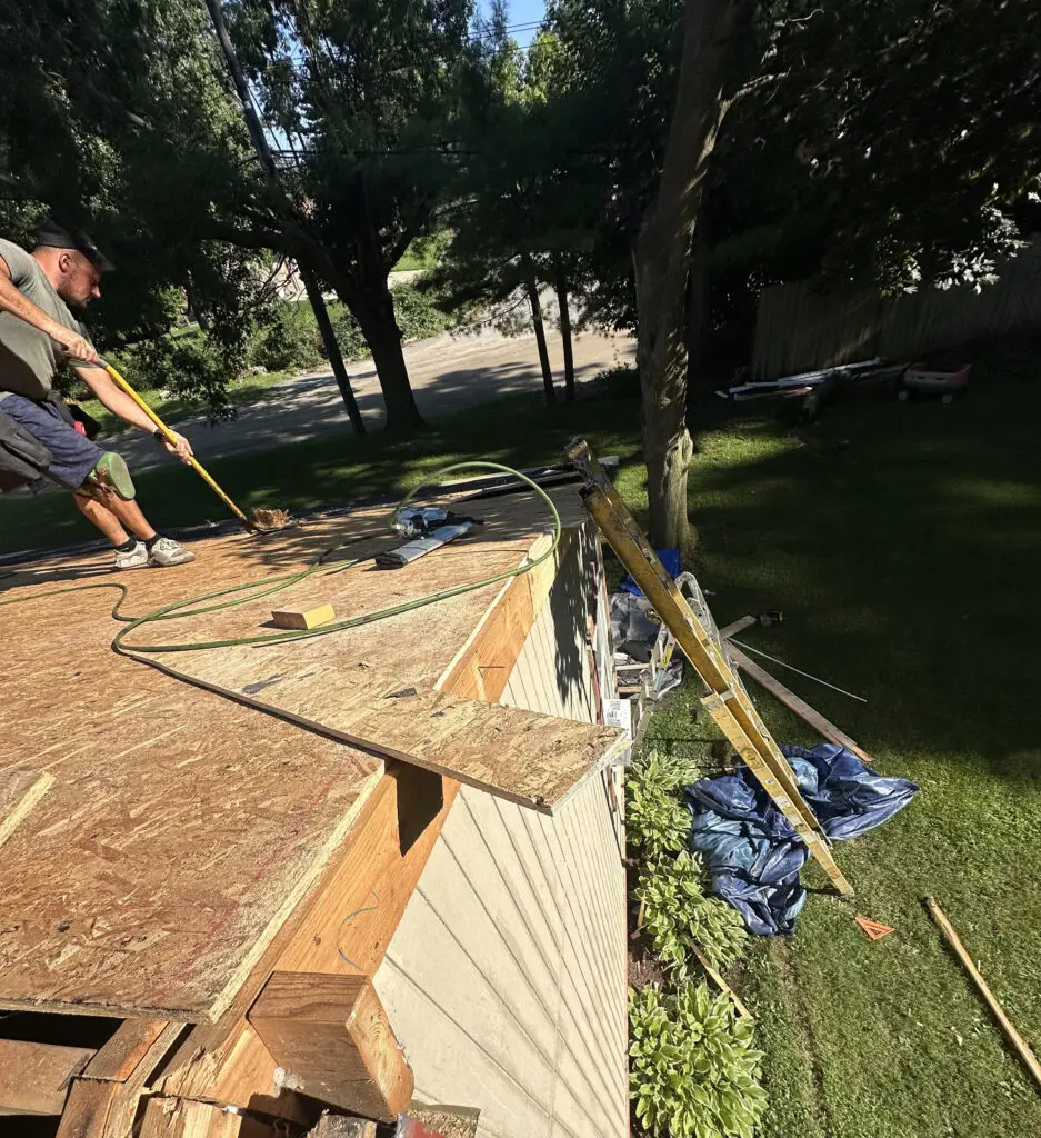 Roof Repair & Installation in Waterford Township with new Skylight 30 roofer repairing damaged roof with new plywood decking installation during replacement in waterford township mi