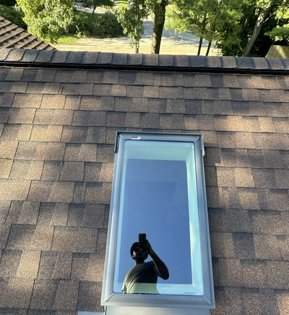 Roof Repair & Installation in Waterford Township with new Skylight 46 skylight window with flashing installed on residential asphalt shingle roof in waterford township mi