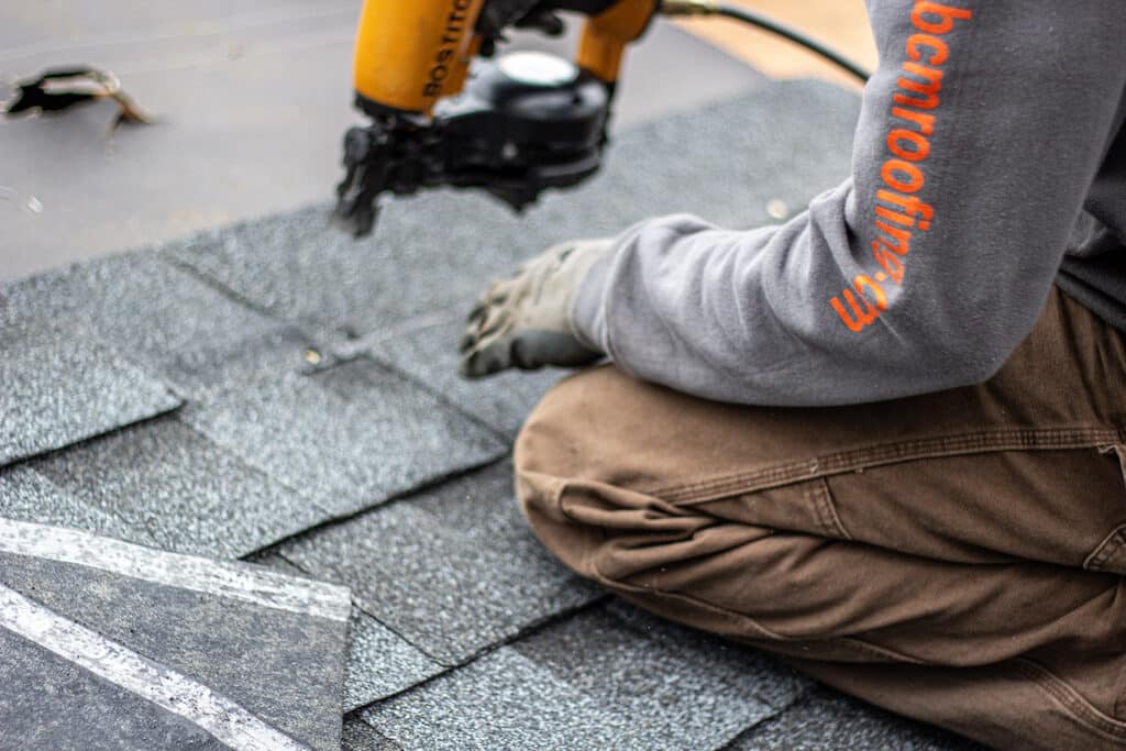 BCM Roofing is a quality roofing contractor installing shingles on a roof in West Bloomfield Michigan