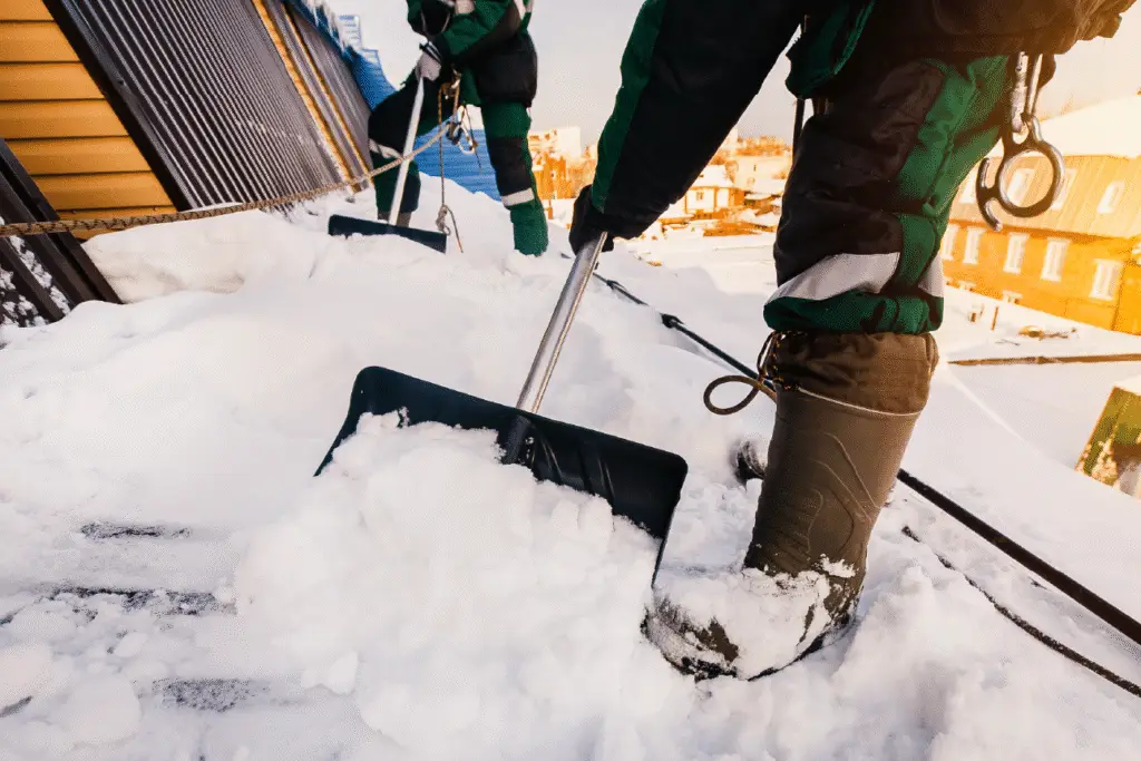 BCM Roofing Contractors complete roof snow removal from residential home.