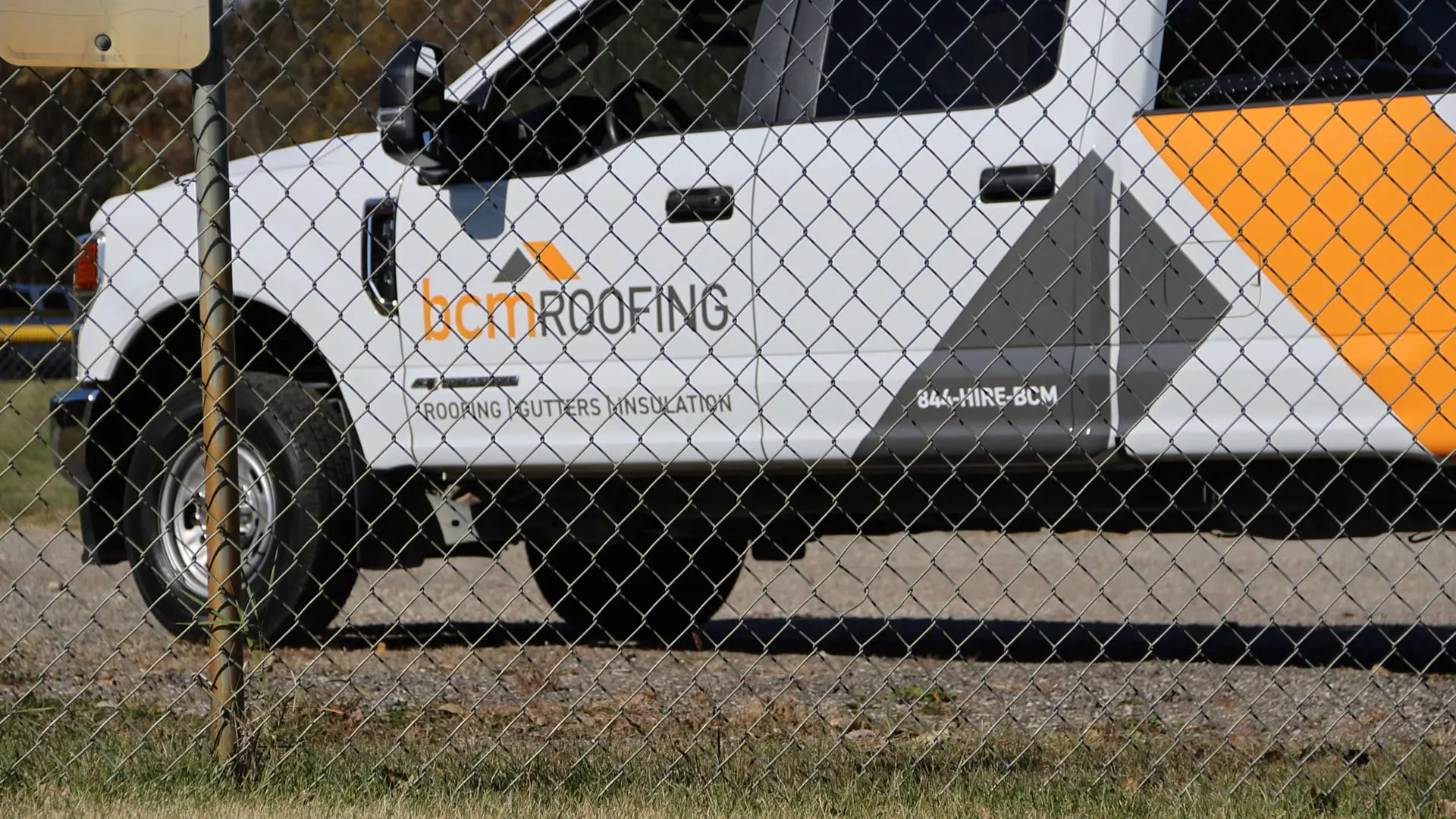 A BCM Roofing crew truck parked at a Southeast Michigan roofing customer property.