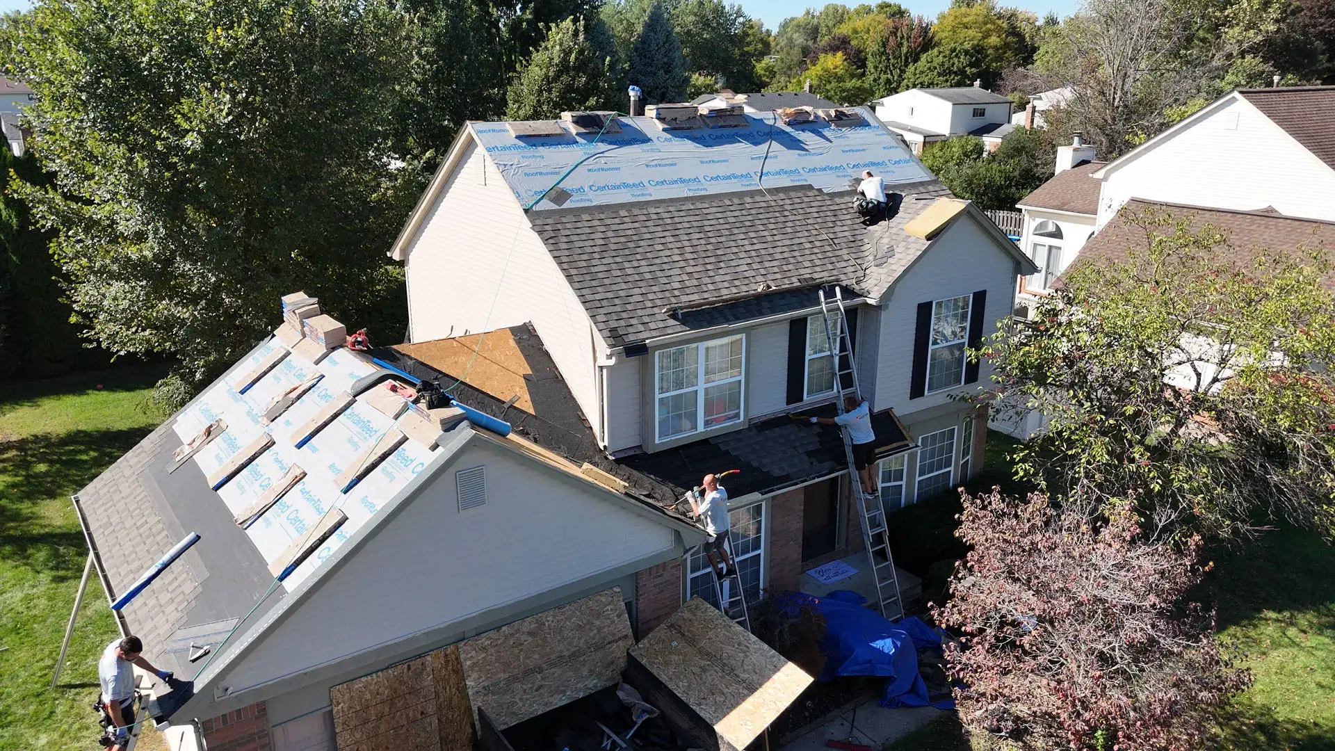Home 10 BCM Roofing crew replacing a roof in Southeast Michigan.