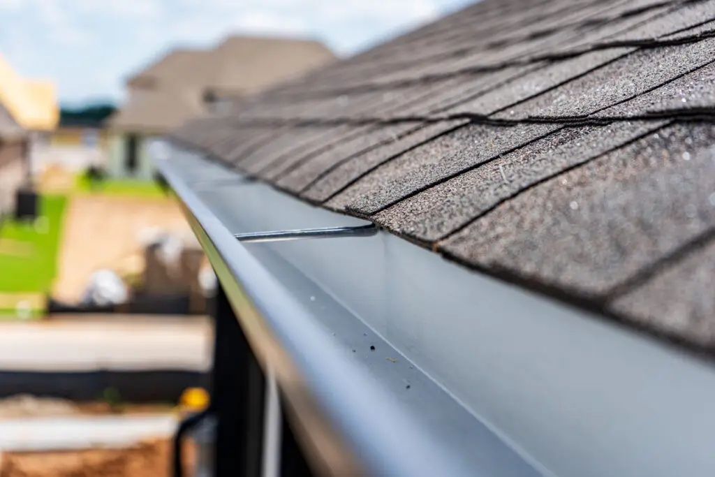 Close-up of finished gutter installation on residential home.