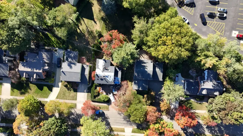 Aerial view of roofing crew replacing residential roof in Imlay City, MI.