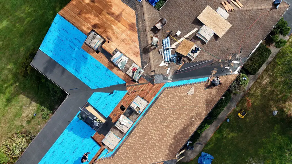 Aerial view of roofing team replacing an asphalt shingle roof in Southfield, MI.