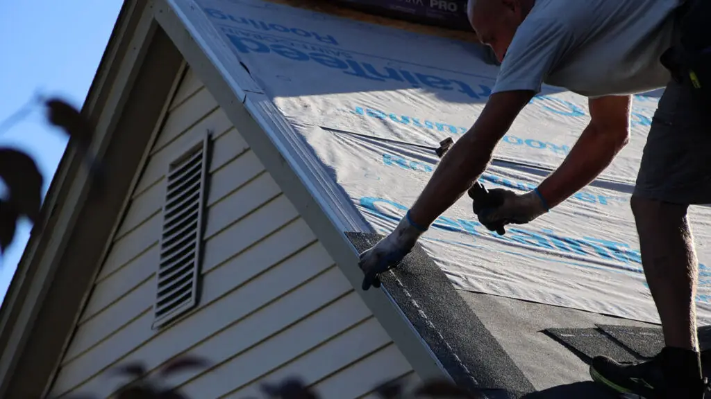 Roofer installing starter shingles during roof replacement in Bloomfield, MI.