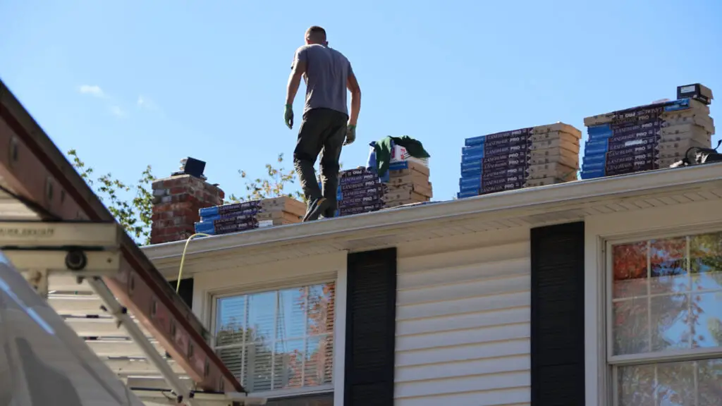 Roofer preparing for a roof replacement in Vienna, MI.